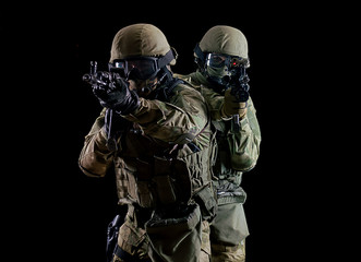 American soldiers in combat ammunition with weapons in the hands of equipped laser sights are in...