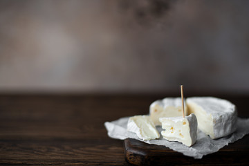 brie cheese sliced on a wooden board
