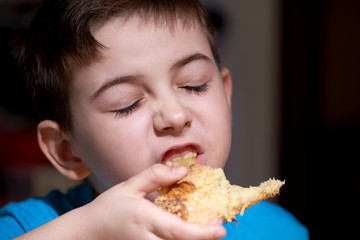 boy, child eats a bun inhales the pleasant aroma of fresh pastries.