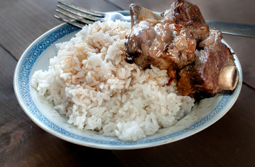 Steam rice with ribs in oyster sauce in a plate, Chinese food, Asian cuisine concept