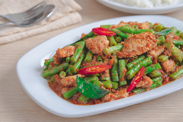 Stir fried pork with yard long bean and red curry paste served with rice, Thai food