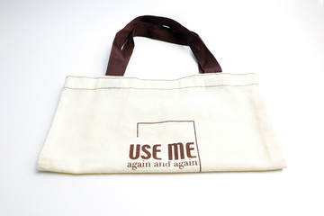 Reuse bags to reduce global warming on a white ground.
