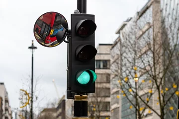 Foto op Plexiglas Green Traffic Light Signal and Traffic Convex Mirror with the Reflection of the red bus, London, England, UK © ako-photography