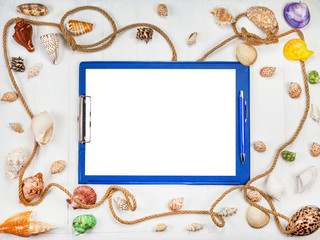 Summer vacation concept. Sea shells with rope on white wooden background, notebook with pen for summer plan, copy space.