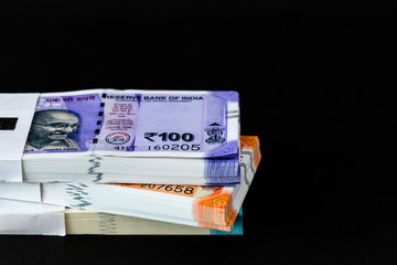 Angle close up shot of three money bundles on black background with copy space for economy concept.