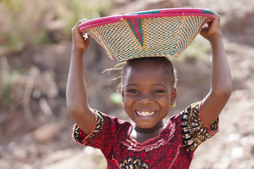Smiling African Ethnic Girl Outdoors with Food Basket, poverty symbol - obrazy, fototapety, plakaty