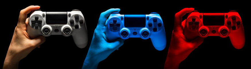 Set of hands holding video game gamepad in neon lights isolated on a black