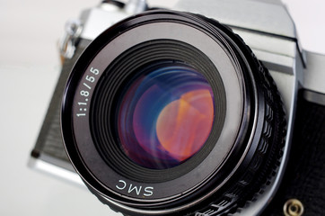 Classic SLR camera on a white background.