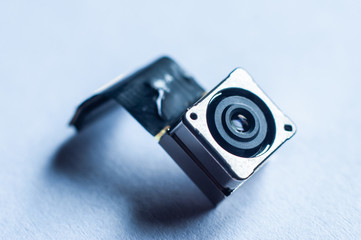 Small camera for tracking people with a connection cable, close-up, macro shot.