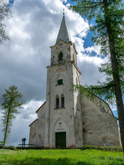 Fototapeta na wymiar white church on the hill, beautiful blue sky with white cumulus clouds, Trikata church, Latvia