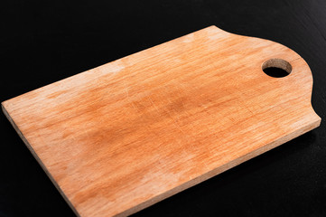 Kitchen wooden board on a black background