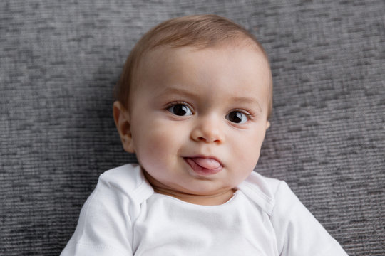 Portrait of cute baby sticking tongue