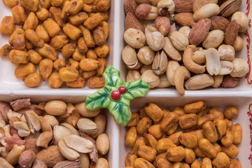 mixed nuts plate on red background. Seed, sauce corn and mixed nuts