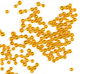 Small balls of gold on a white background.