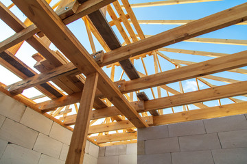 Fototapeta premium Wooden boards on the roof of the house against the sky.