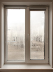 A window with fogged windows in the room.