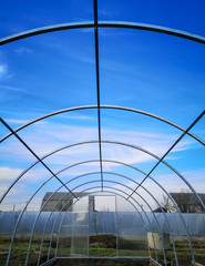 Fototapeta premium Frame for the greenhouse against the sky.