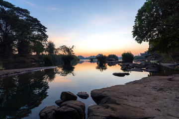 Beautiful landscape view of sunrise and old wooden boat drop nearly the river in front of guest house from Don Det the famous place for tourist to relaxing at Siphondon island, Laos.