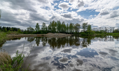 calm scene of beautiful sky with cumulus clouds reflection on the lake