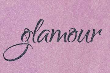 Glamour lettering word gray (midnight blue black) on light pink (ballet slipper) glitter texture. Shiny sparkle background