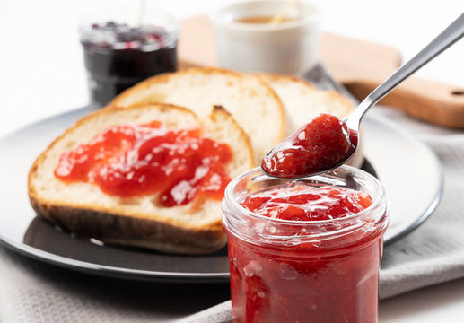 Breakfast image of a jam-smeared loaf of bread