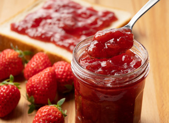 Strawberry jam placed in the background of a tree