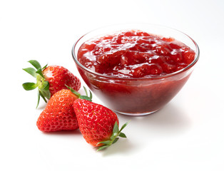 Strawberry jam and strawberry fruit placed on a white background
