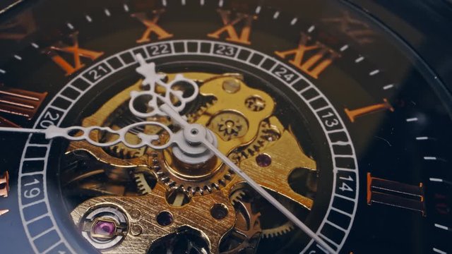 Sliding shot over clock mechanism running gear in extreme macro 4k