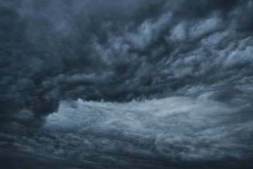 Naklejka na ściany i meble Dark dramatic clouds before a thunderstorm, hurricane, tornado.Abstract sky background.