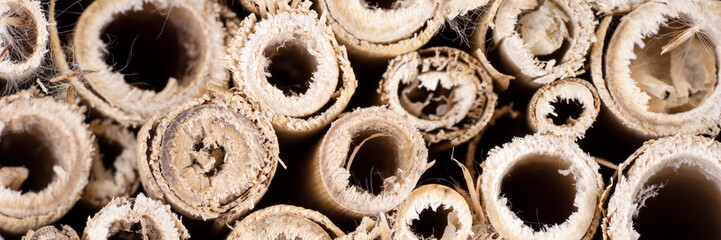Panoramic image. Closeup wooden Insect hotel. Shelter for insects made in wood
