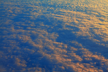 endless clouds illuminated by sunlight , view from above