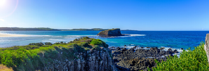 Australian landscape panorama view of the mouth of the Minnamurra river, out to Stack Island in the...