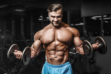 Plakat Bodybuilder strong man pumping up biceps muscles