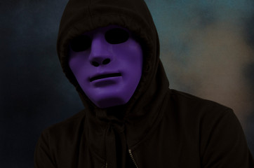 Mystery hollow man in violet mask and black coat