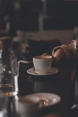 cup of coffee on the table in the hand