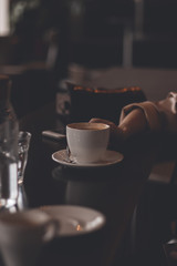 hands with coffee in the cafe