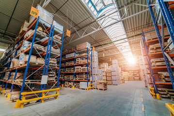 Warehouse storage of a retail goods store. Rows of shelves with boxes