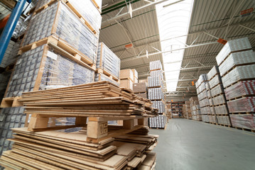 Huge distribution warehouse with boxes on high shelves. Interior of modern warehouse.