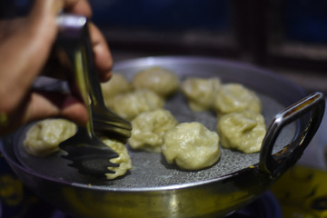 after corona virus lockdown avery restaurant and shops close so woman making momo at home, stay home stay safe, life during lockdown in India 