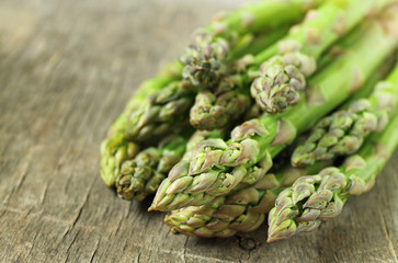 Banches of fresh green asparagus on a wooden background. Healty food