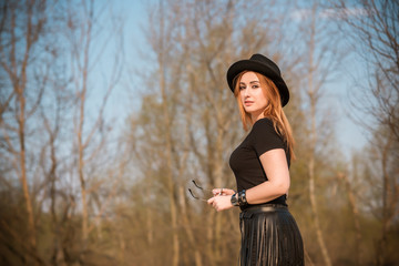 Fashionable outfit details, plus size girl with Large size in fringe belt and fedora hat mix style