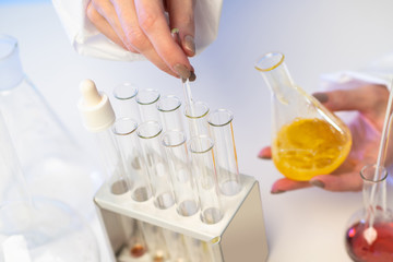 Test tube and flasks with chemical reagents. Demonstration of the experiment in chemistry class. Analysis of the composition of synthetic detergents. Quality control of raw materials for production.