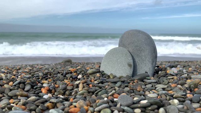 Oamaru beach stony sea, View of rocky beach ocean on sun light in the summer. At Awamoa Beach, Oamaru, New Zealand. 4K UHD, Video Clip with copy or text space.