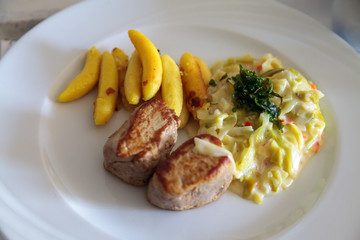 Close up of a healthy lunch with pork medallions