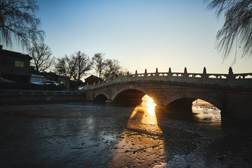 bridge over frozen lake in beijing