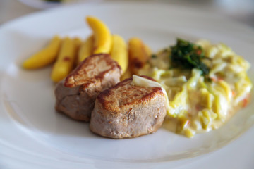 Close up of a healthy lunch with pork medallions