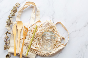 Set of Eco friendly bamboo cutlery on white marble background. Sustainable lifestyle. Plastic free concept. Flat lay, top view, mockup