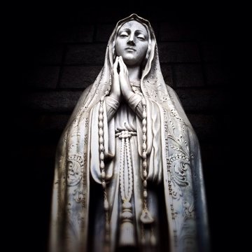 Low Angle View Of Virgin Mary Statue Against Wall