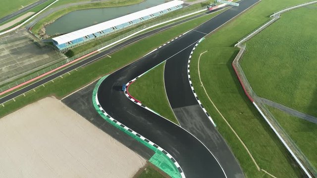 Car taking the racing line through S bend on race track