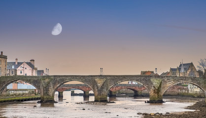 The Old Brigg Looking down the River early in the Morning in Ayr Scotland. Early Morning Sky with a...